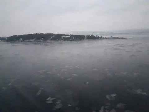 Floating pieces of ice on a cloudy day at sea Stock Photos