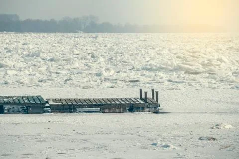 Floating pier damaged by ice at river side Stock Photos