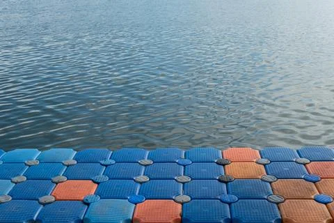 Floating pier made of composite plastic blocks on the river, sea. Plastic b.. Stock Photos