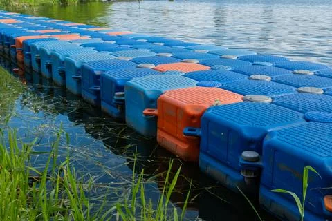 Floating pier made of composite plastic blocks on the river, sea. Plastic bridge Stock Photos