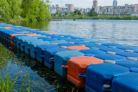 Floating pier made of composite plastic blocks on the river, sea. Plastic b.. Stock Photos