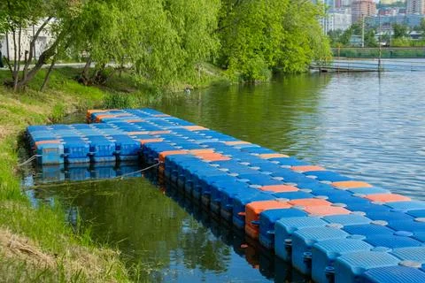 Floating pier made of composite plastic blocks on the river, sea. Plastic b.. 写真素材