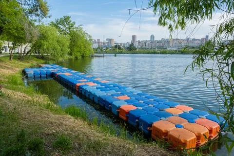 Floating pier made of composite plastic blocks on the river, sea. Plastic bridge Stock Photos