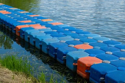 Floating pier made of composite plastic blocks on the river, sea. Plastic bridge 写真素材