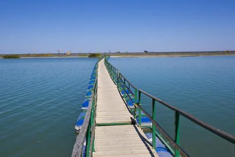 Floating Pier Over Calm Water on Sunny Day Stock Photos