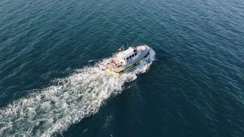 Floating pilot ship on calm surface of sea water on blue surface of sea Stock Footage 136160906