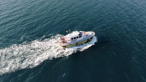 Floating pilot ship on calm surface of sea water on blue surface of sea Stock Footage 136160932