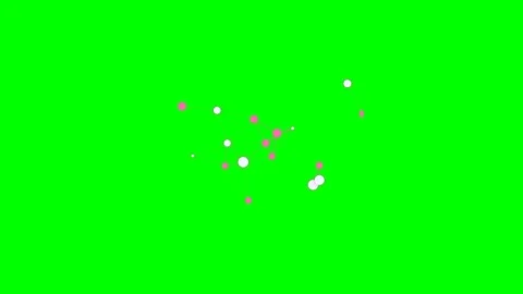 Floating pink and white confetti circles isolated on a bright green backgroun Vídeos de archivo 340265935