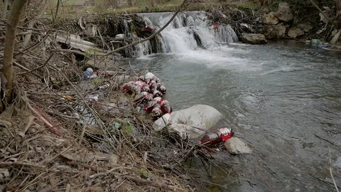 Floating plastic beer bottles Stock Footage 106798583
