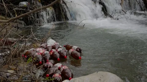 Floating  plastic beer bottles Stock Footage 106798655