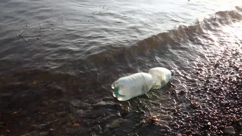 Floating plastic bottle in the lake Stock Footage 107779272