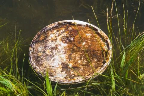 Floating plastic  in the small river. Plastic pollution Stock Photos