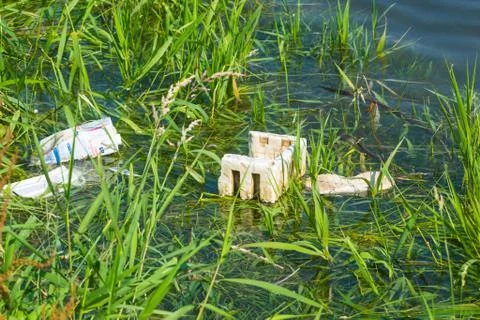 Floating plastic  in the small river. Plastic pollution Foto stock
