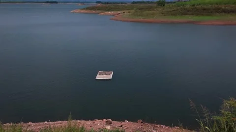 A floating platform is seen on Ray Lake in Vietnam. The water is still and Stock Footage 336502570