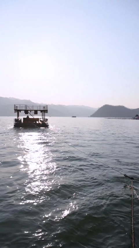 Floating Raft on Calm Mountain Lake at Sunset Stock Footage 344038022