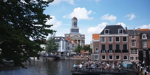 Floating restaurant in Leiden, The Netherlands; Hartebrug Church in background Stock Footage 59185039