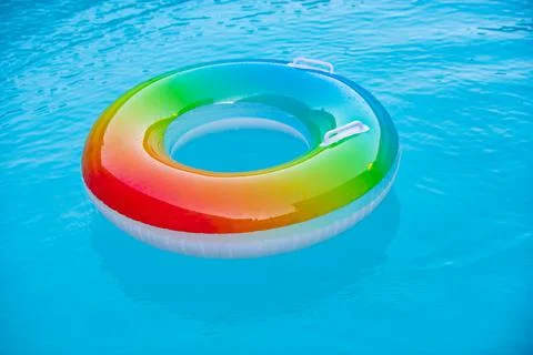 Floating ring on blue water pool with waves reflecting in the summer. Blue aqua 스톡 사진