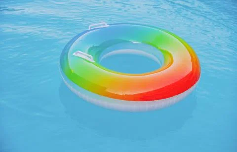 Floating ring on blue water pool with waves reflecting in the summer. Blue aqua 스톡 사진