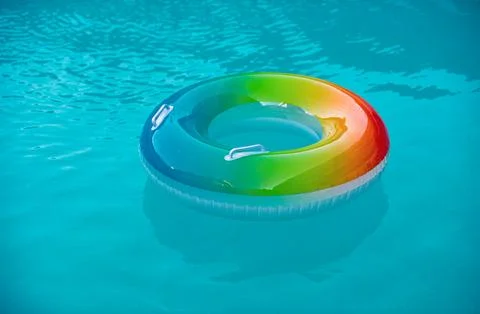 Floating ring on water pool in the summer. Float in blue swimming pool. Active Stock Photos