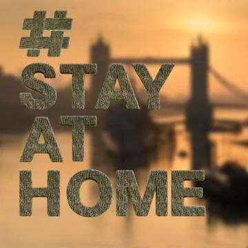 Floating rock style letters in front of London Bridge reading #StayatHome in  Stock Photos