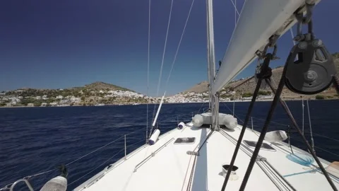 Floating sailing yacht with spread sails splitting the sea waves Stock Footage 238942792