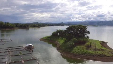 Floating shanty, fish cages built on the lake hydro electric dam reservoir Stock Footage