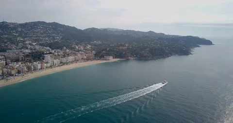 Floating ship on the background of the beach and city Lloret de Mar 01 Stock Footage 91154409