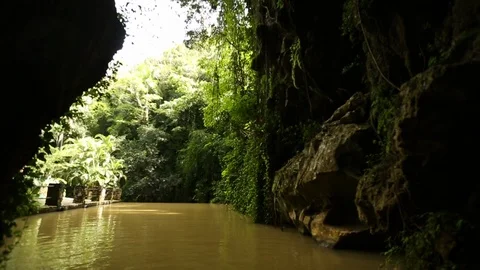 Floating Slowly Down Murky River Surrounded By Lush Green Jungle 스톡 동영상 125784026