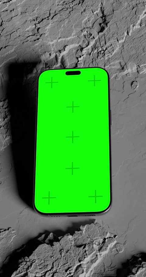 Floating smartphone with green screen above rocky surface, dynamic lighting.. Stock Footage 310718835