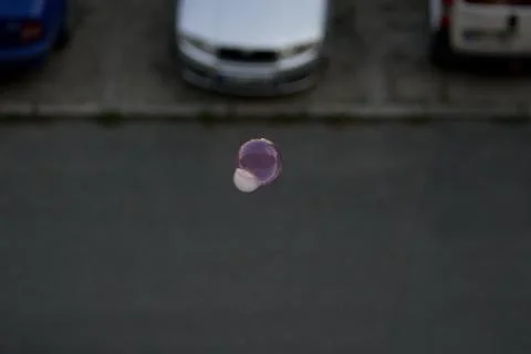Floating soap bubbles filled with smoke in the center of the town. Stock Photos