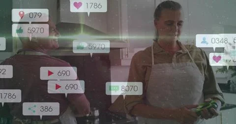 Floating social bubbles overlaying man at stove and woman in apron prepping Stock Photos