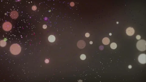 Floating soft golden bokeh particles drift across dark background with creating 스톡 동영상 345330932