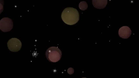 Floating soft golden circular bokeh orbs drifting across dark background with 库存影片 340943126