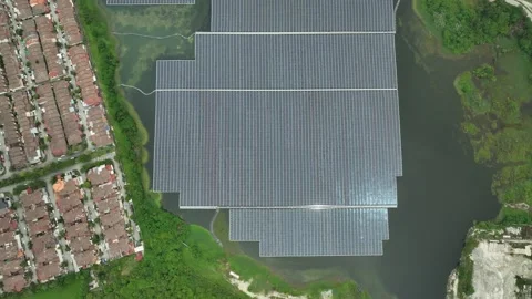 Floating Solar Farm Array on Water Near Residential Area Stockbeeldmateriaal 337330644