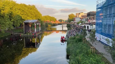 Floating stage and crowd gathered along the Ems River embankment during a s.. Stockbeeldmateriaal 346297707