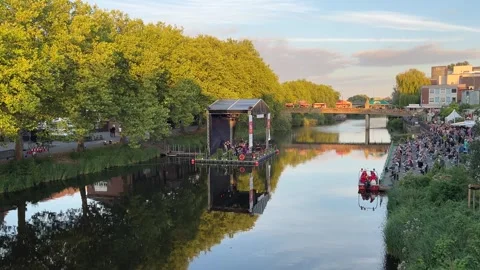 Floating stage and crowd gathered along the Ems River embankment during a s.. Stockbeeldmateriaal 346297951