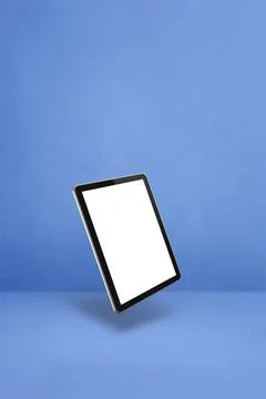Floating tablet pc computer isolated on blue. Vertical background Blank ta... Stock Photos