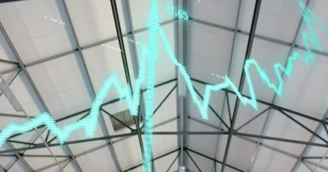 Floating teal line graph crossing pitched roof inside warehouse, showing steel Foto stock