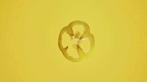 Floating Transparent Slice of Lemon in Yellow Liquid Stock Footage 306351976