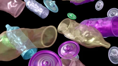 Floating unrolled condoms and ring-like shape rolled up condoms Stock Footage 314408427