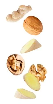 Floating walnuts and ginger isolated on white background Stock Photos