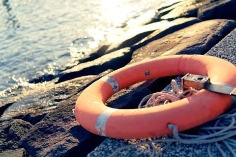 Floating wheels placed in the riverside Stock Photos