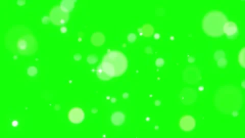 Floating white bokeh particles rising against a vivid green screen background Vídeo Stock 344714573