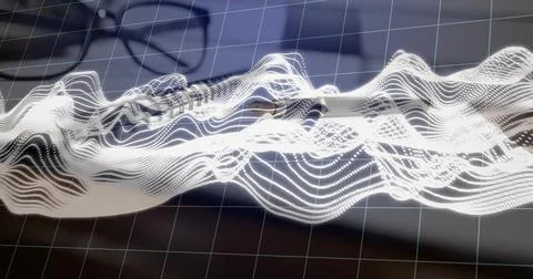 Floating white dotted waveform crossing grid overlay on desk, with laptop Stock Photos