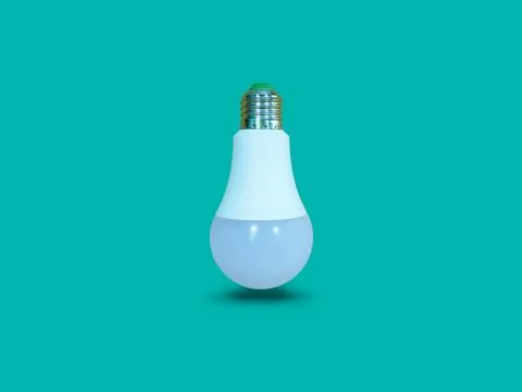 Floating white LED light bulb isolated on turquoise color background. Stock Photos