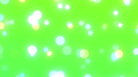 Floating white light bokeh particles moving on a solid green screen background Stock Footage 345807800