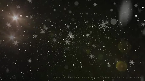 Floating white snowflakes falling against dark night background with glowing Stock Footage 340942922