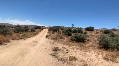 Floating wide angle view of a dusty &amp; lonely desert road near Rimrock California Stock Footage 113767360