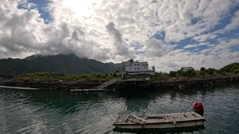 Floating wooden dock with red buoy near white coastal house Lofoten Stock-Footage 344047552