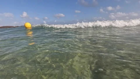 Floating Yellow Buoy And Waves Crashing Onto The Rocks 動画素材 278495056